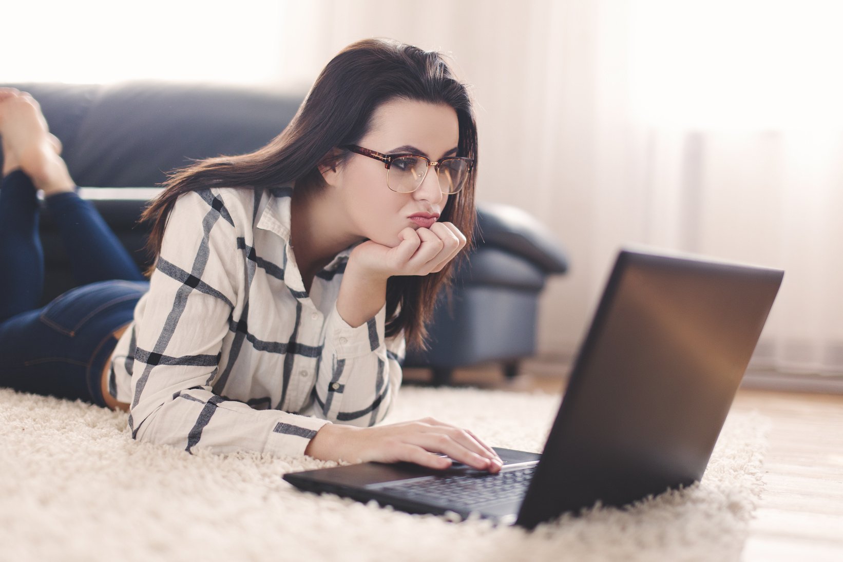 Woman searching for boys online on laptop indoor